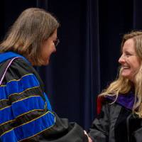 Faculty awardee shaking Christine's hand